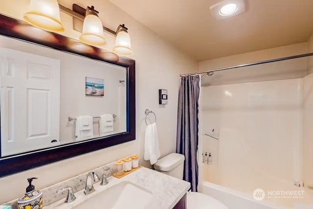 full bathroom featuring shower / tub combo with curtain, vanity, and toilet