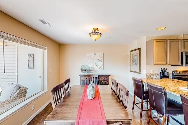 dining room with dark hardwood / wood-style floors