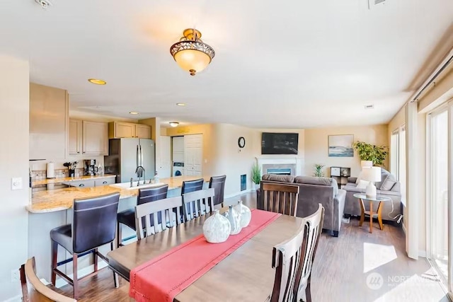 dining room featuring light wood-type flooring and sink