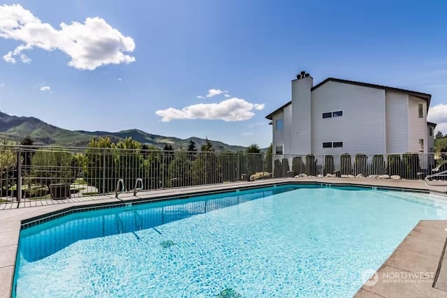 view of swimming pool with a mountain view