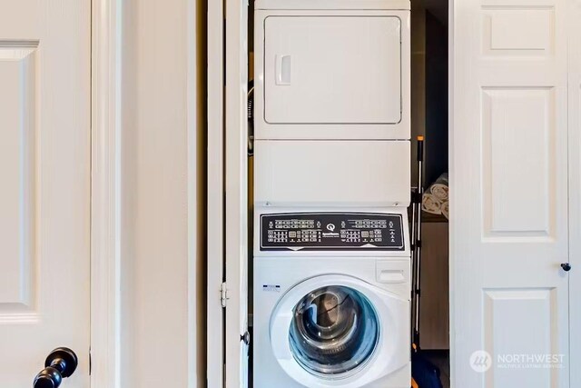 laundry room with stacked washer / drying machine