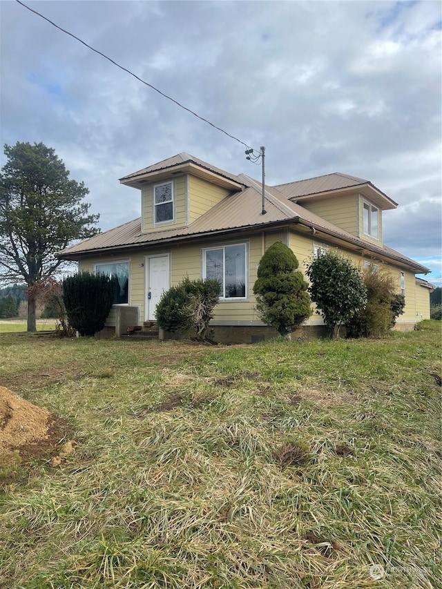 view of home's exterior featuring a lawn