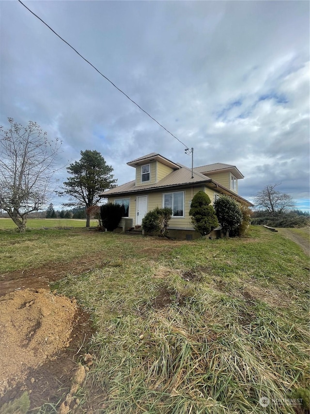 view of side of property with a yard