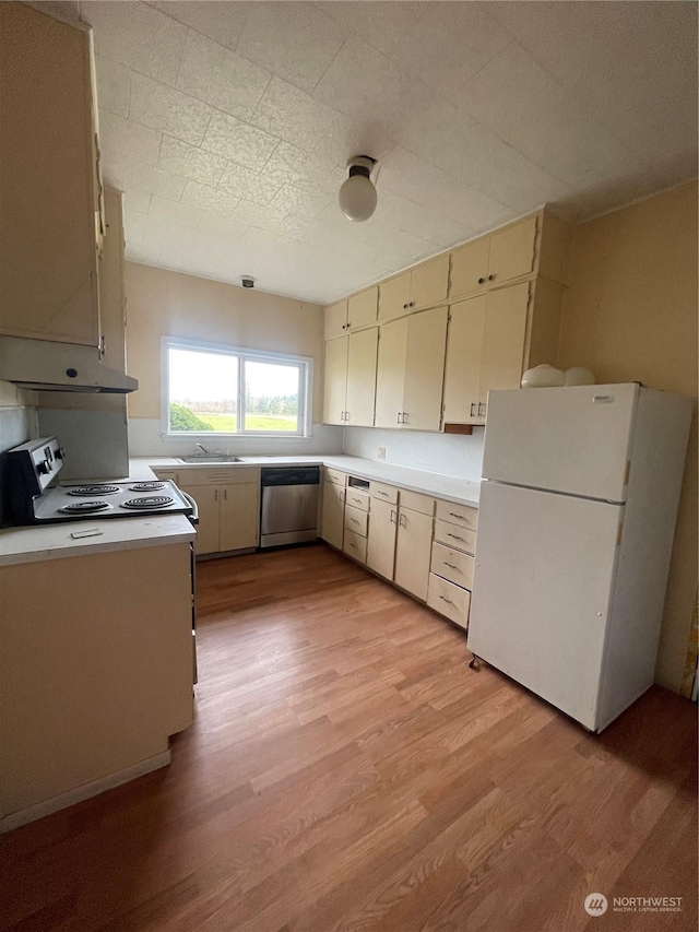 kitchen with white refrigerator, range with electric cooktop, sink, dishwasher, and light wood-type flooring