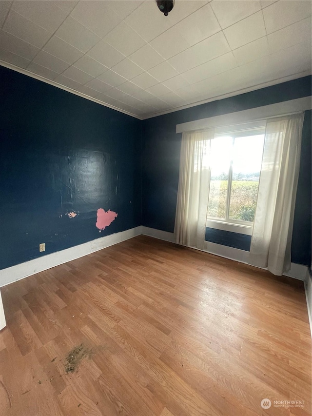 unfurnished room featuring hardwood / wood-style flooring