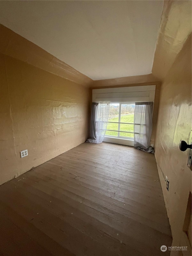 unfurnished room featuring hardwood / wood-style flooring