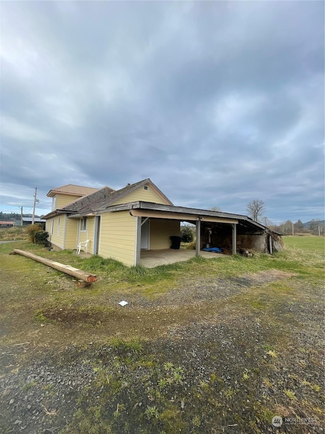 view of property exterior featuring a carport