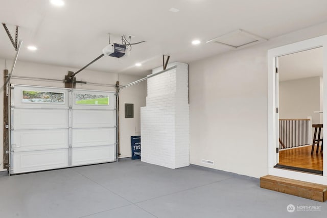 garage featuring electric panel and a garage door opener