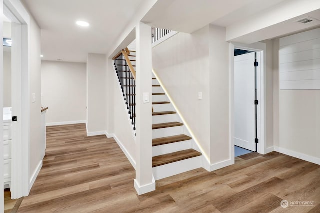 staircase featuring hardwood / wood-style floors