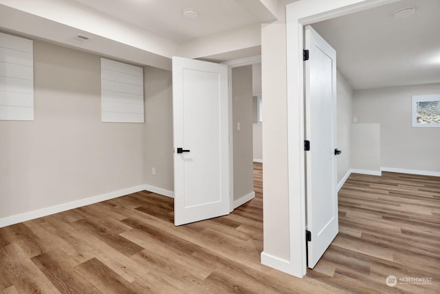 basement featuring light hardwood / wood-style floors