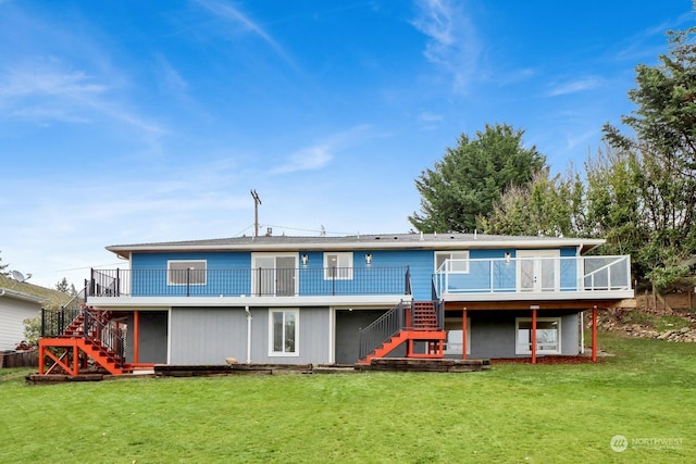 rear view of house with a lawn and a deck