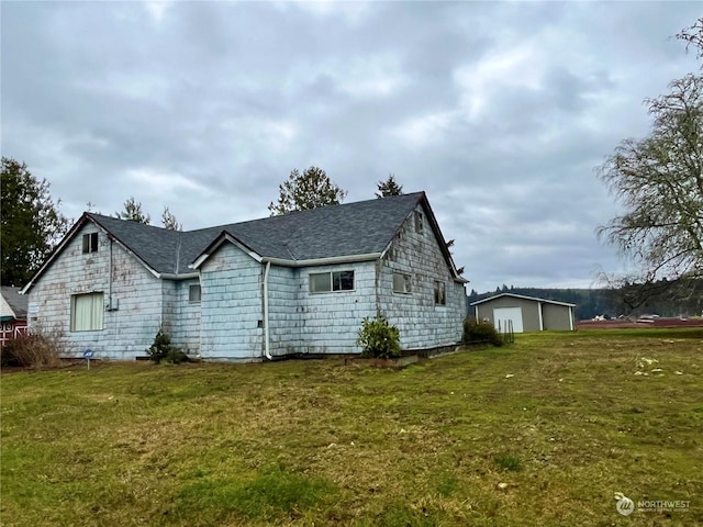 rear view of property featuring a lawn