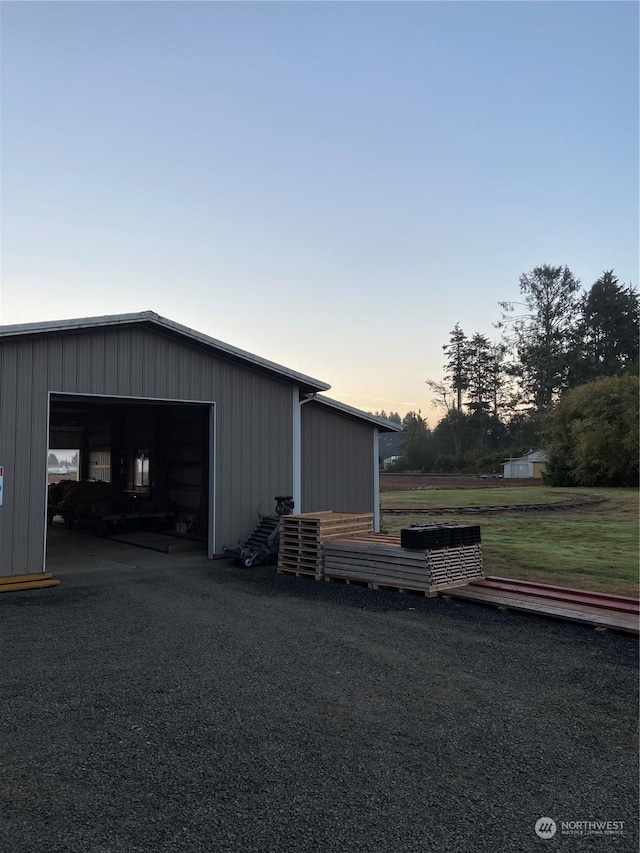 view of garage at dusk