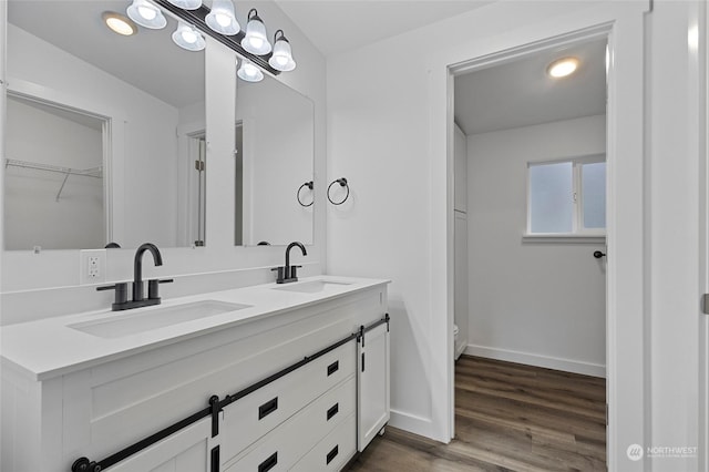 bathroom with vanity, toilet, and wood-type flooring