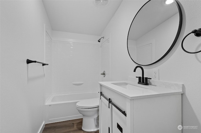 full bathroom featuring hardwood / wood-style flooring, vanity, shower / bathtub combination, and toilet