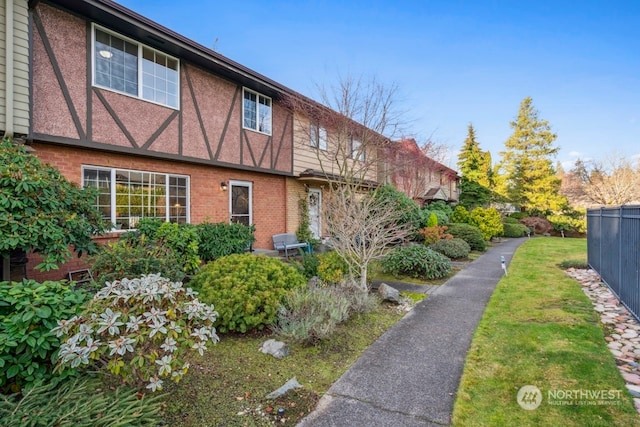 view of side of property with a lawn