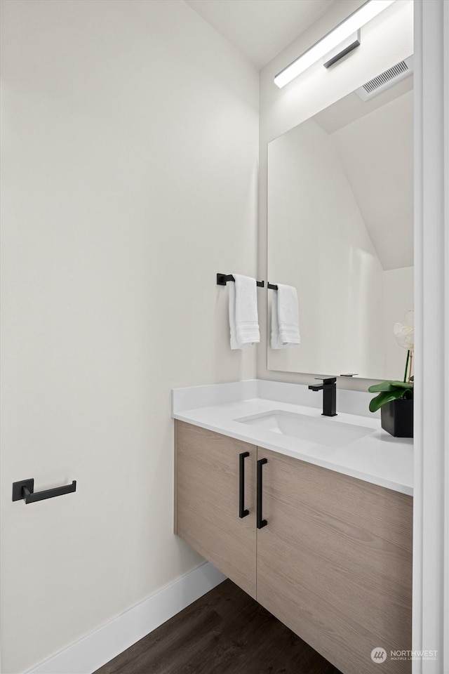 bathroom featuring vanity and hardwood / wood-style flooring