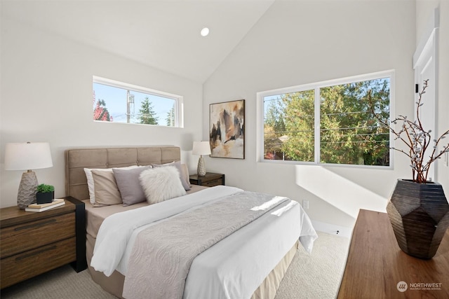 carpeted bedroom featuring multiple windows and high vaulted ceiling