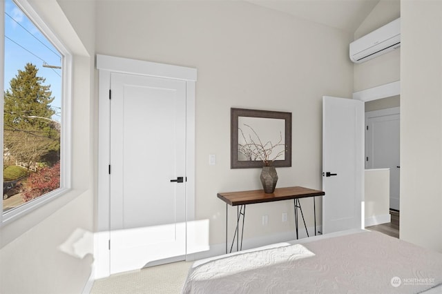 bedroom featuring a wall unit AC, lofted ceiling, and hardwood / wood-style flooring