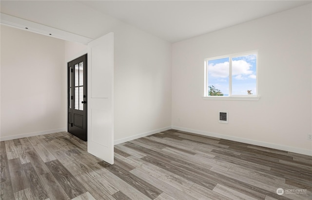 unfurnished room featuring hardwood / wood-style floors