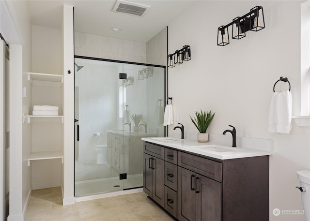 bathroom with a shower with door and vanity