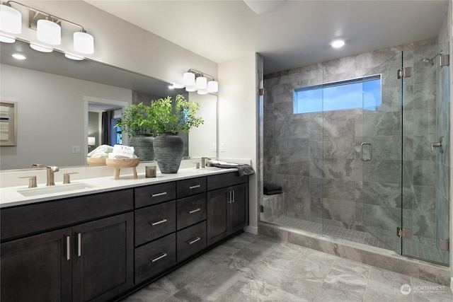 bathroom featuring vanity and a shower with door