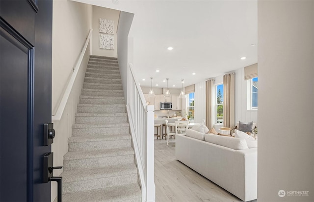 stairs with hardwood / wood-style flooring