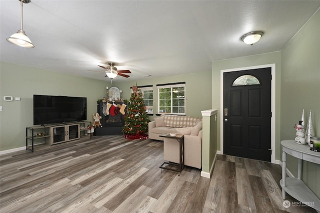 living room featuring hardwood / wood-style flooring and ceiling fan