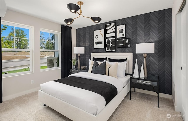 carpeted bedroom with an inviting chandelier and a closet