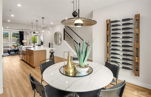 dining room with light wood-type flooring and sink