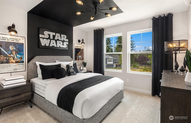 carpeted bedroom with an inviting chandelier