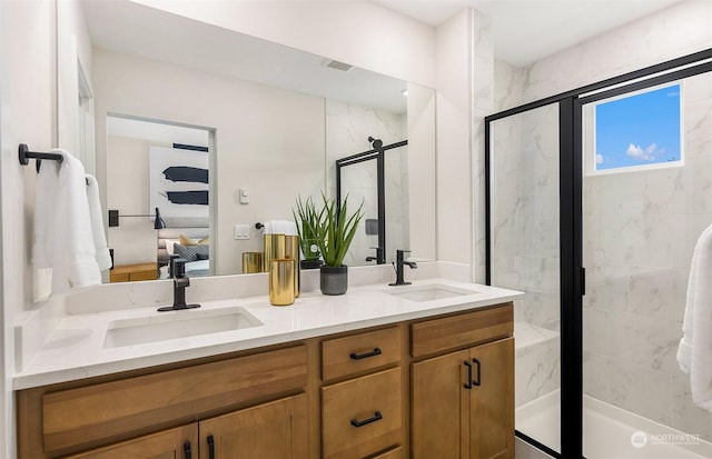 bathroom featuring vanity and a shower with door