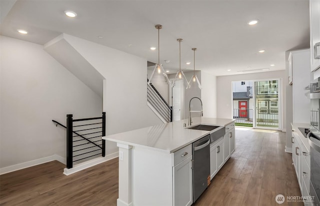 9014 NE 203rd Ln Unit C, Bothell, WA 98011 - kitchen featuring a sink, dishwasher, a kitchen island with sink, wood finished floors, and baseboards