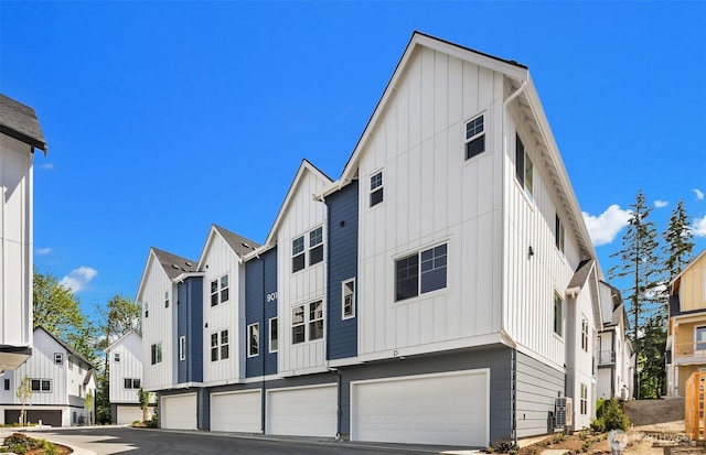 9014 NE 203rd Ln Unit C, Bothell, WA 98011 - view of front of home featuring board and batten siding, an attached garage, a residential view, and driveway