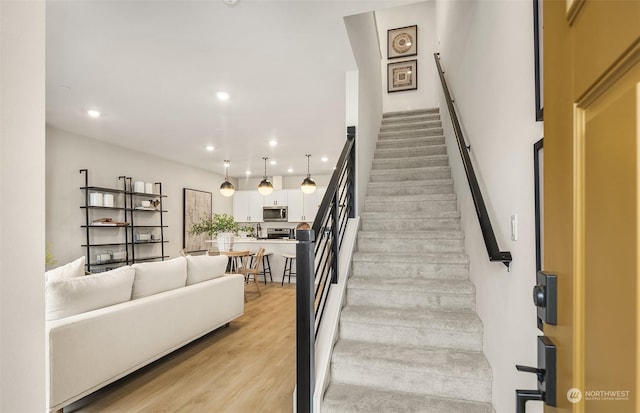 stairs with wood-type flooring