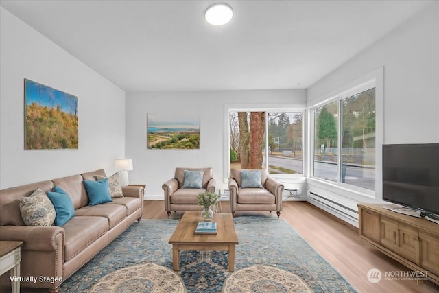 living room featuring baseboard heating and light hardwood / wood-style flooring