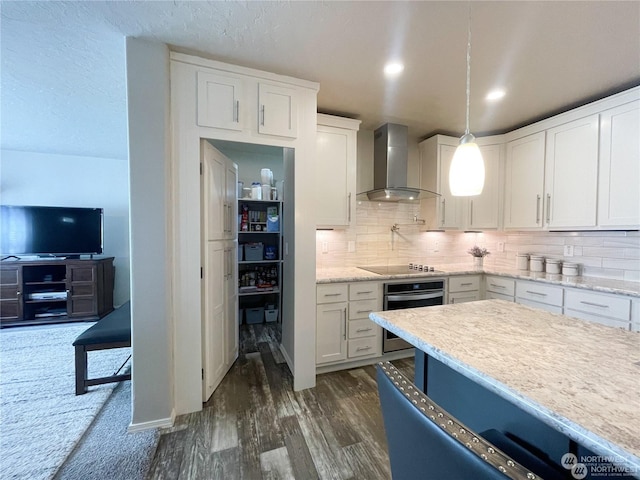 kitchen with white cabinetry, stainless steel oven, wall chimney exhaust hood, dark hardwood / wood-style floors, and pendant lighting