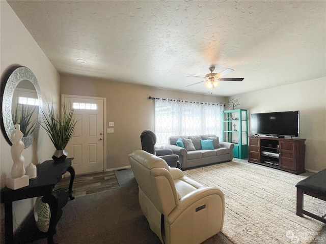 living room with ceiling fan, hardwood / wood-style floors, and a textured ceiling