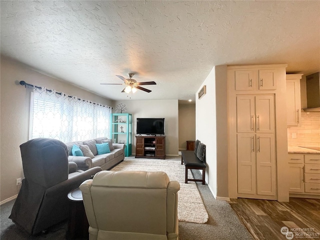 living room with wood-type flooring, a textured ceiling, and ceiling fan