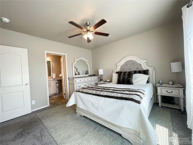 carpeted bedroom with ensuite bathroom and ceiling fan