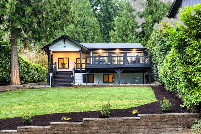 back of property featuring a yard and a deck