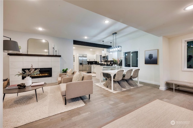 living room with a fireplace and light hardwood / wood-style flooring