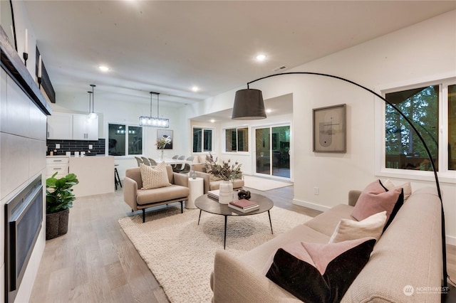 living room featuring light wood-type flooring and a healthy amount of sunlight