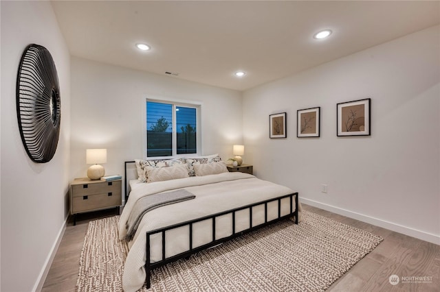 bedroom with hardwood / wood-style flooring