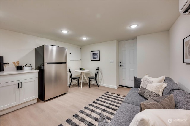 living room with light wood-type flooring and a wall mounted AC