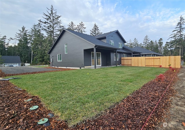 back of house featuring a yard