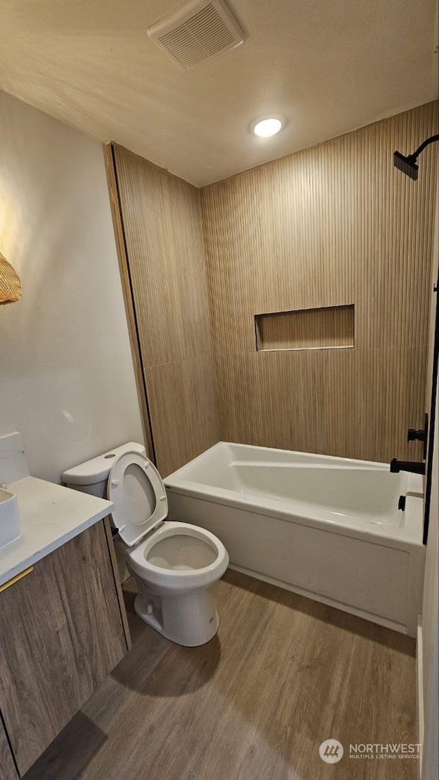 full bathroom with vanity, wood-type flooring, shower / washtub combination, and toilet