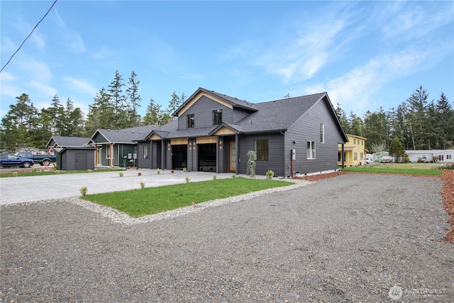 view of front of home featuring a garage, driveway, and a shingled roof