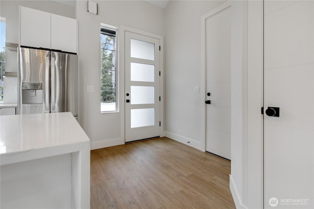 entryway featuring light wood-type flooring and baseboards