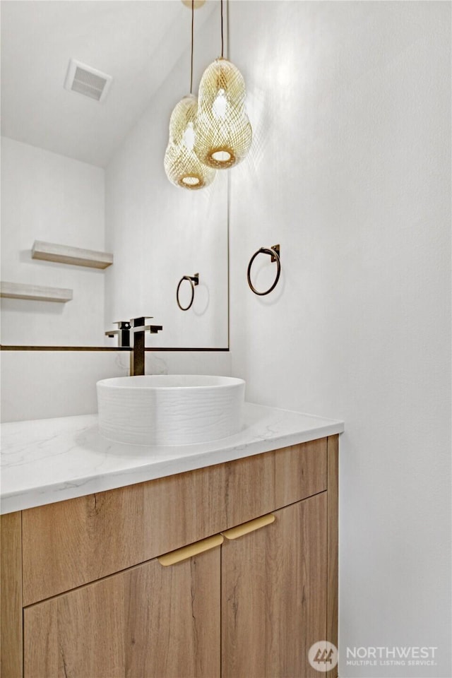 bathroom with visible vents and vanity